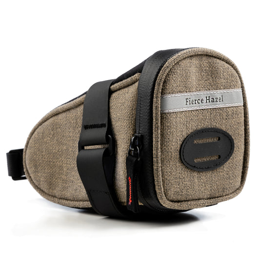 The True Grit Saddle Bag by Fierce Hazel is photographed on a white background. It is made fro eco-friendly Olefin