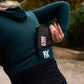 Woman using the Fierce Hazel Ultra Fierce Weatherproof Wallet. Designed for cycling, gravel rides, bikepacking, travel, and every day wallet. Phone case and eco-friendly.