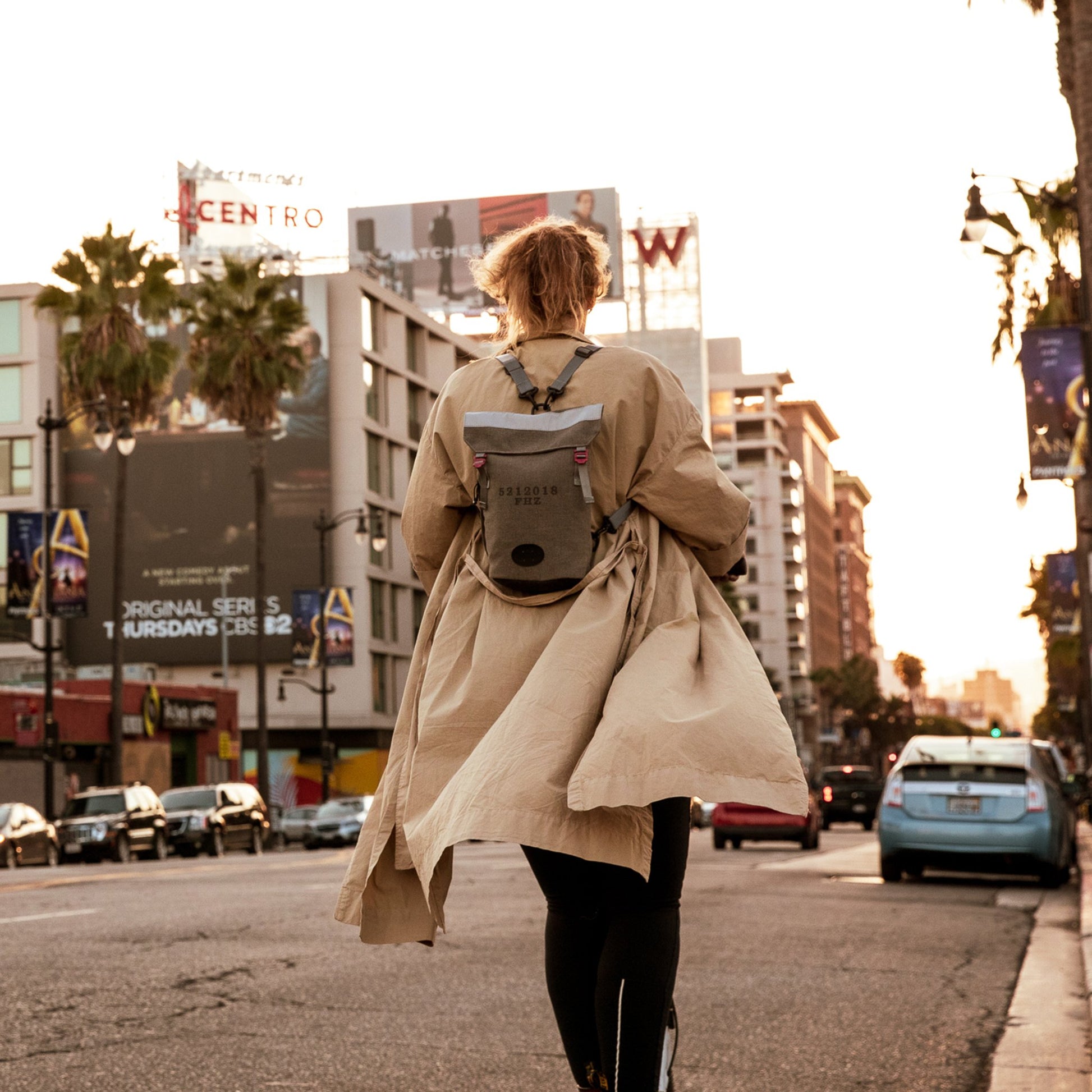 Woman on scooter with a Fierce Hazel convertible backpack in Los Angeles California. It is durable, water-resistant, lightweight and strong