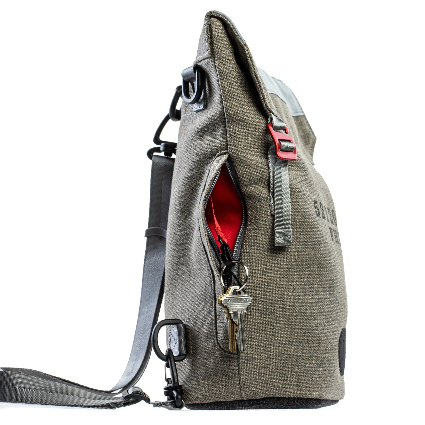 Side view of a Fierce Hazel convertible backpack made with sustainable fabric. Red interior and key clip. Functional, rugged and water-resistant it is military styled but beautiful